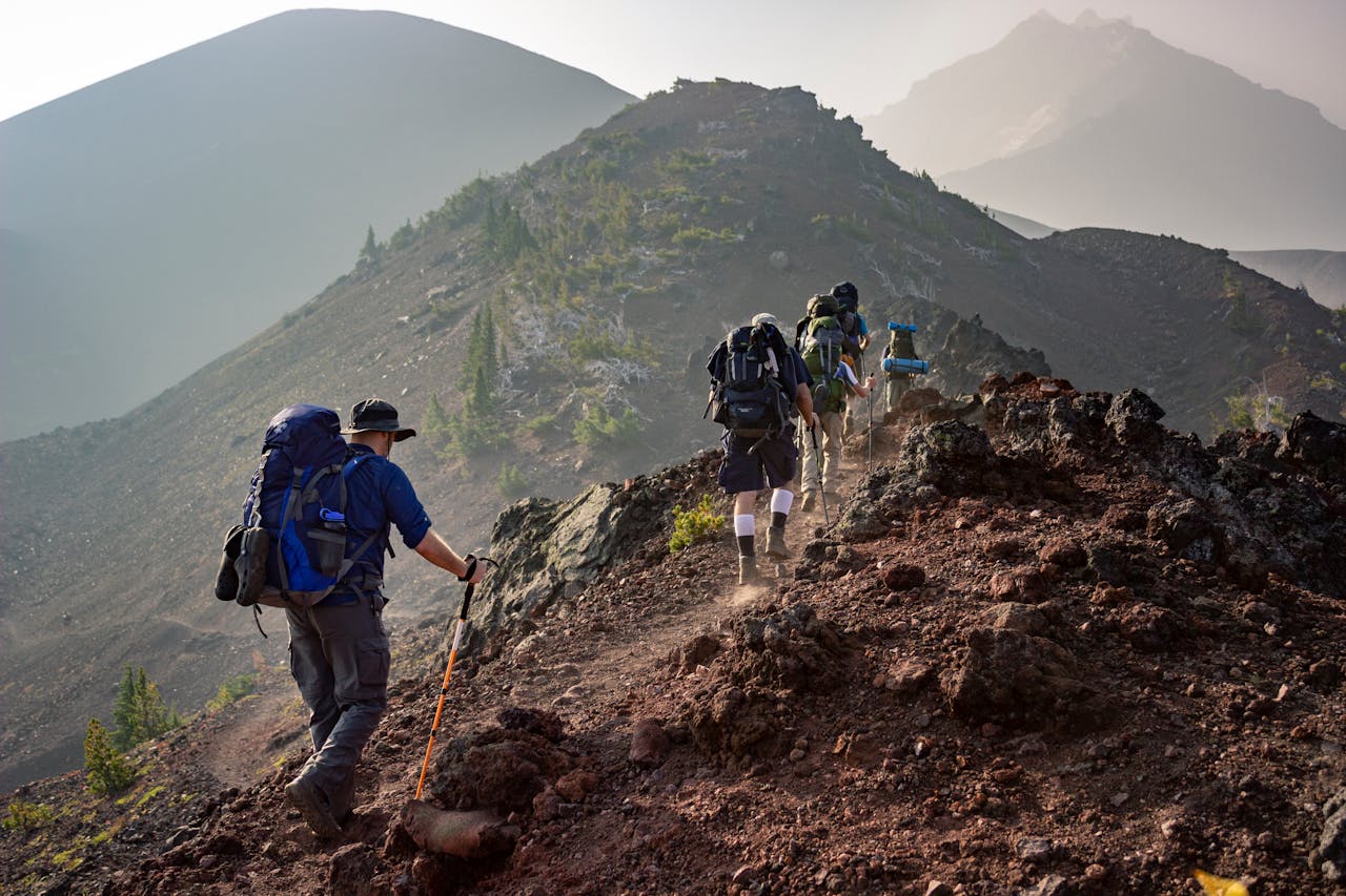 Group of hikers trekking on a rugged mountain trail in Oregons scenic outdoors.